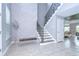 Modern staircase with metal railing in two-story foyer at 2406 High Tides Way, Wesley Chapel, FL 33543