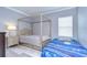 Bedroom with canopy bed and a dresser at 2406 High Tides Way, Wesley Chapel, FL 33543