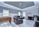 Game room with leather sectional, foosball table, and wood-look floors at 2406 High Tides Way, Wesley Chapel, FL 33543
