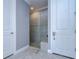 Walk-in shower with glass enclosure and grey tile surround at 2406 High Tides Way, Wesley Chapel, FL 33543