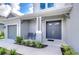 House exterior with gray siding, double front doors, and a two-car garage at 2406 High Tides Way, Wesley Chapel, FL 33543
