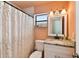 Bathroom with shower/tub combo, granite vanity, and peach walls at 301 N Glen Ave, Tampa, FL 33609