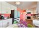 Modern kitchen with white cabinets, granite counters and coral walls at 301 N Glen Ave, Tampa, FL 33609