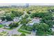 Aerial view showing a home's location within a leafy, residential neighborhood, near a city skyline at 301 N Glen Ave, Tampa, FL 33609