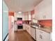 White kitchen cabinets, granite countertops, and stainless steel appliances at 301 N Glen Ave, Tampa, FL 33609