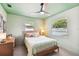 Bedroom with light green walls and a wooden bed frame at 301 N Glen Ave, Tampa, FL 33609