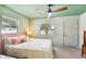 Bright bedroom with a wooden bed frame and backyard view at 301 N Glen Ave, Tampa, FL 33609