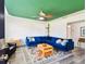 Bright living room features a blue sectional sofa, wood coffee table, and green ceiling at 301 N Glen Ave, Tampa, FL 33609
