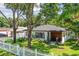 Renovated home with white exterior, gray roof, and lush landscaping at 301 N Glen Ave, Tampa, FL 33609