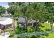 Aerial view of a charming house with a fenced yard and mature trees at 301 N Glen Ave, Tampa, FL 33609