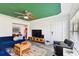 Living room with blue sofa, wood media console, and green ceiling at 301 N Glen Ave, Tampa, FL 33609
