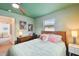 Light green bedroom with wooden bed frame and access to another room at 301 N Glen Ave, Tampa, FL 33609