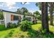 Charming house with white exterior, wood accents, and landscaping at 301 N Glen Ave, Tampa, FL 33609