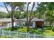 Cute bungalow with white exterior, gray roof, and a well-manicured lawn at 301 N Glen Ave, Tampa, FL 33609