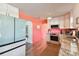 Bright kitchen with white cabinets, granite counters, and a teal refrigerator at 301 N Glen Ave, Tampa, FL 33609