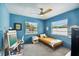 Blue bedroom with twin bed, workspace, and cheerful decor at 301 N Glen Ave, Tampa, FL 33609
