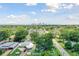Aerial view showing a house nestled amongst lush greenery with a cityscape in the distance at 301 N Glen Ave, Tampa, FL 33609