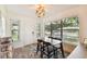 Bright dining area with a wooden table, four chairs, and large windows at 301 N Glen Ave, Tampa, FL 33609