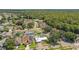 Aerial view of a residential neighborhood, featuring a house with solar panels at 8703 Charming Knoll Ct, Tampa, FL 33635