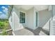 Front entrance with a teal door and a paved walkway at 2613 Star Apple Way, Sarasota, FL 34240