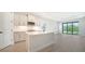 Modern kitchen with white cabinets, stainless steel appliances, and an island at 2613 Star Apple Way, Sarasota, FL 34240