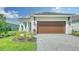 Modern home with inviting front yard and paver driveway at 2613 Star Apple Way, Sarasota, FL 34240