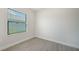Simple bedroom with gray tile floors and a window with blinds at 2613 Star Apple Way, Sarasota, FL 34240