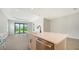 Modern kitchen with stainless steel appliances and island, view to backyard at 2613 Star Apple Way, Sarasota, FL 34240