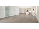Open living space with gray tile flooring and views into the kitchen at 2613 Star Apple Way, Sarasota, FL 34240