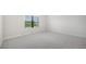Spacious bedroom with carpeted floor and window at 2613 Star Apple Way, Sarasota, FL 34240
