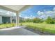 Landscaped backyard with a patio and view of neighboring homes at 2613 Star Apple Way, Sarasota, FL 34240