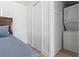 Bedroom with a bed, closet, and stackable washer/dryer at 609 N Osceola Ave, Clearwater, FL 33755