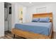 Bedroom with wood-framed bed, hardwood floors, and laundry access at 609 N Osceola Ave, Clearwater, FL 33755