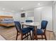 Bright bedroom with wood-framed bed, hardwood floors, and dining table at 609 N Osceola Ave, Clearwater, FL 33755