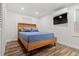 Cozy bedroom with wood-framed bed and hardwood floors at 609 N Osceola Ave, Clearwater, FL 33755