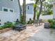 Relaxing patio with fire pit, seating area, and lush landscaping at 609 N Osceola Ave, Clearwater, FL 33755
