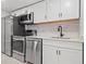 Modern kitchen with stainless steel appliances and white cabinets at 609 N Osceola Ave, Clearwater, FL 33755