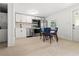 Modern kitchen with white cabinets, stainless steel appliances, and dining area at 609 N Osceola Ave, Clearwater, FL 33755