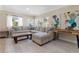 Spacious living room featuring a large sectional sofa and light hardwood floors at 609 N Osceola Ave, Clearwater, FL 33755