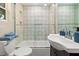 Clean bathroom with a patterned tile shower/tub combo and white vanity at 609 N Osceola Ave, Clearwater, FL 33755