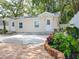 Updated exterior of a charming light-beige house with landscaping at 609 N Osceola Ave, Clearwater, FL 33755