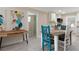 Kitchen dining area with rustic table and teal chairs at 609 N Osceola Ave, Clearwater, FL 33755