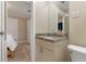 Small bathroom with granite vanity and toilet at 609 N Osceola Ave, Clearwater, FL 33755