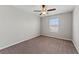 Carpeted bedroom with a window and ceiling fan at 10549 Lake Montauk Dr, Riverview, FL 33578