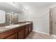 Double vanity bathroom with granite countertop and shower at 10549 Lake Montauk Dr, Riverview, FL 33578