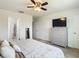 Bright bedroom with a king-size bed, dresser, and access to a bathroom at 11650 Cambium Crown Dr, Riverview, FL 33569