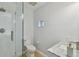 Modern bathroom featuring a glass shower, white marble vanity, and neutral tones at 4950 Bayshore Blvd # 23, Tampa, FL 33611