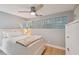 Comfortable bedroom with glass block window, wood floors, ceiling fan, and built-in storage at 4950 Bayshore Blvd # 23, Tampa, FL 33611