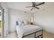 Cozy bedroom with light wood floors, fan, and access to a bright bathroom at 4950 Bayshore Blvd # 23, Tampa, FL 33611