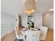 Dining area with round table set for four, stylish chandelier, and access to the staircase at 4950 Bayshore Blvd # 23, Tampa, FL 33611